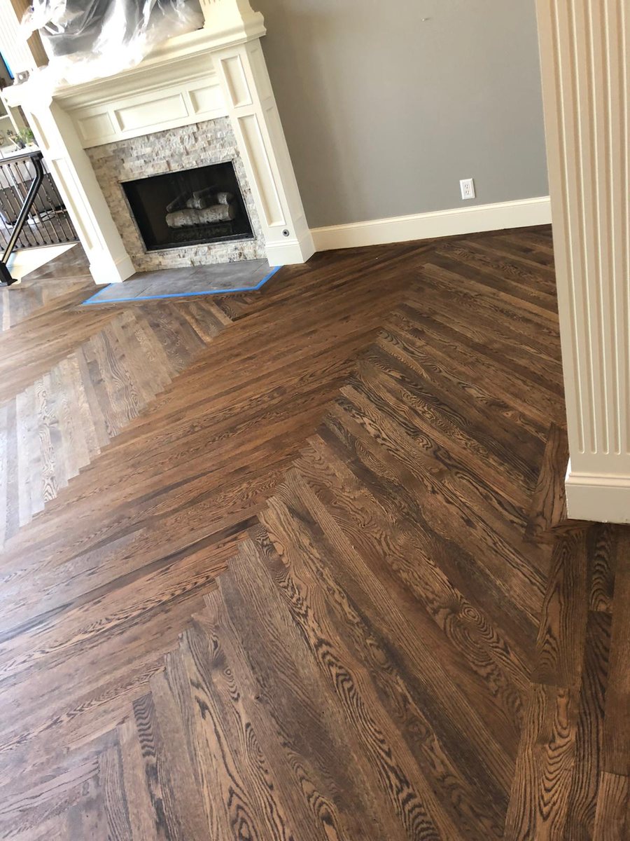 Warm wood floor in an open room with a fireplace