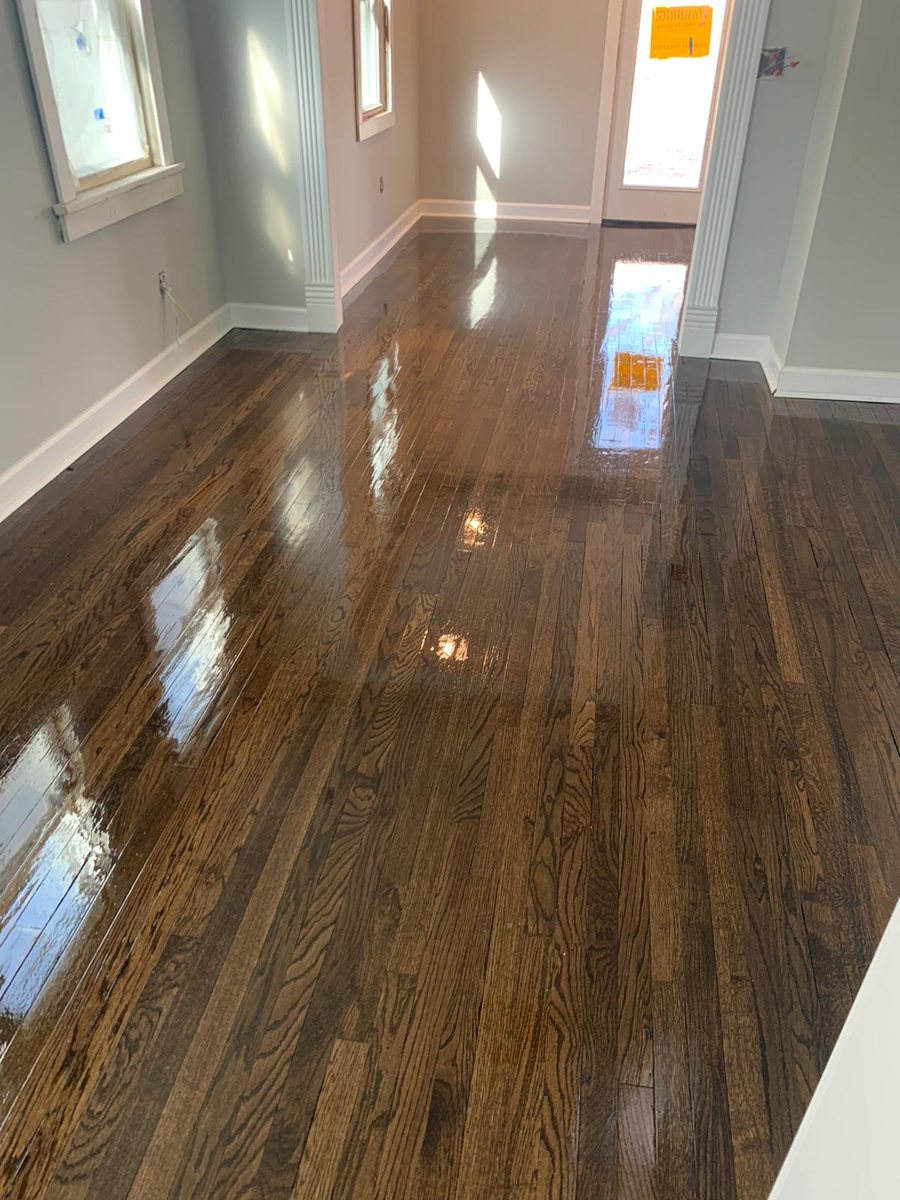 Deep brown wood floor in a bright open room