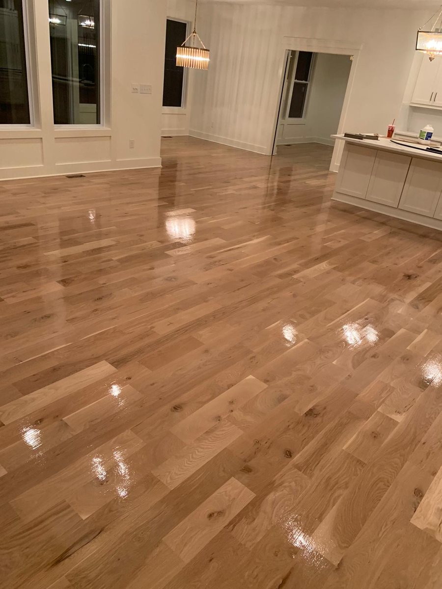 Polished light wood floor in a wide room
