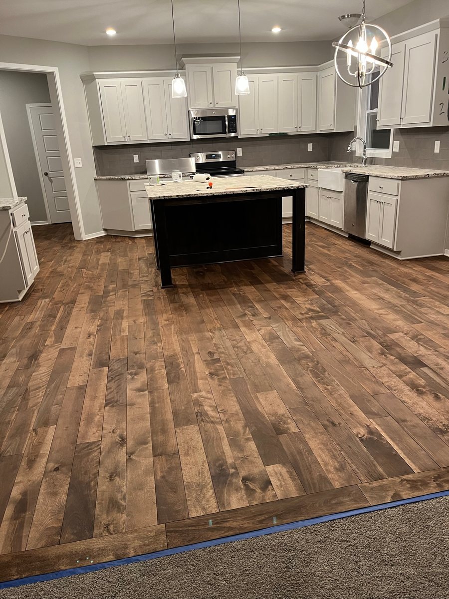 Mixed-tone wood floor in a kitchen with an island