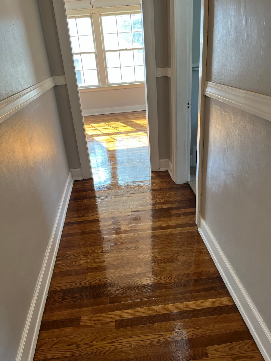 Glossy wood floor running through a hallway
